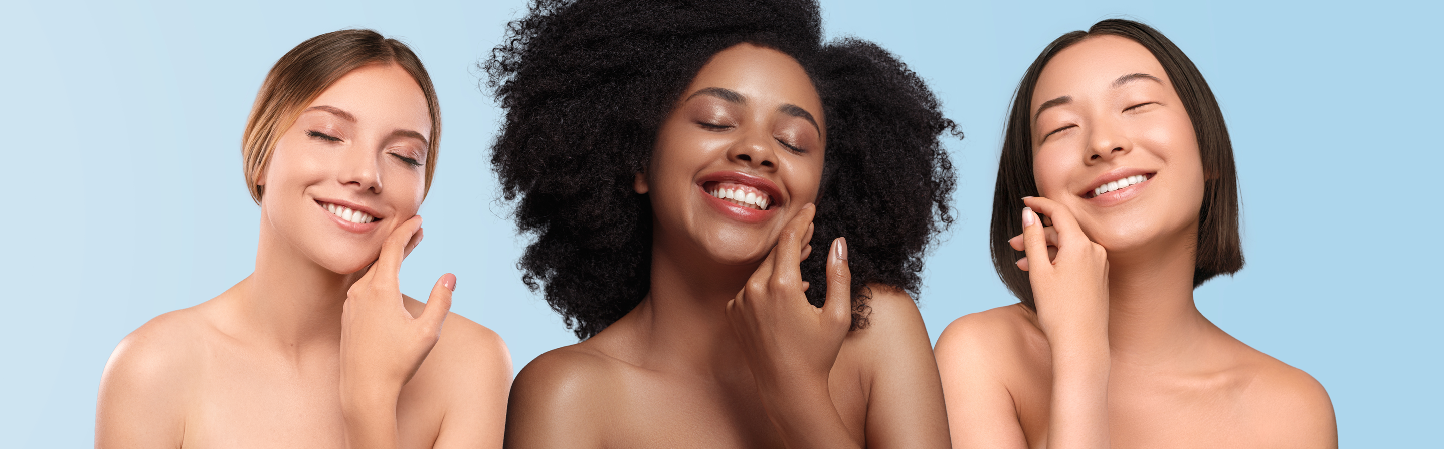 Three women with different skin tones and textures on a light blue background