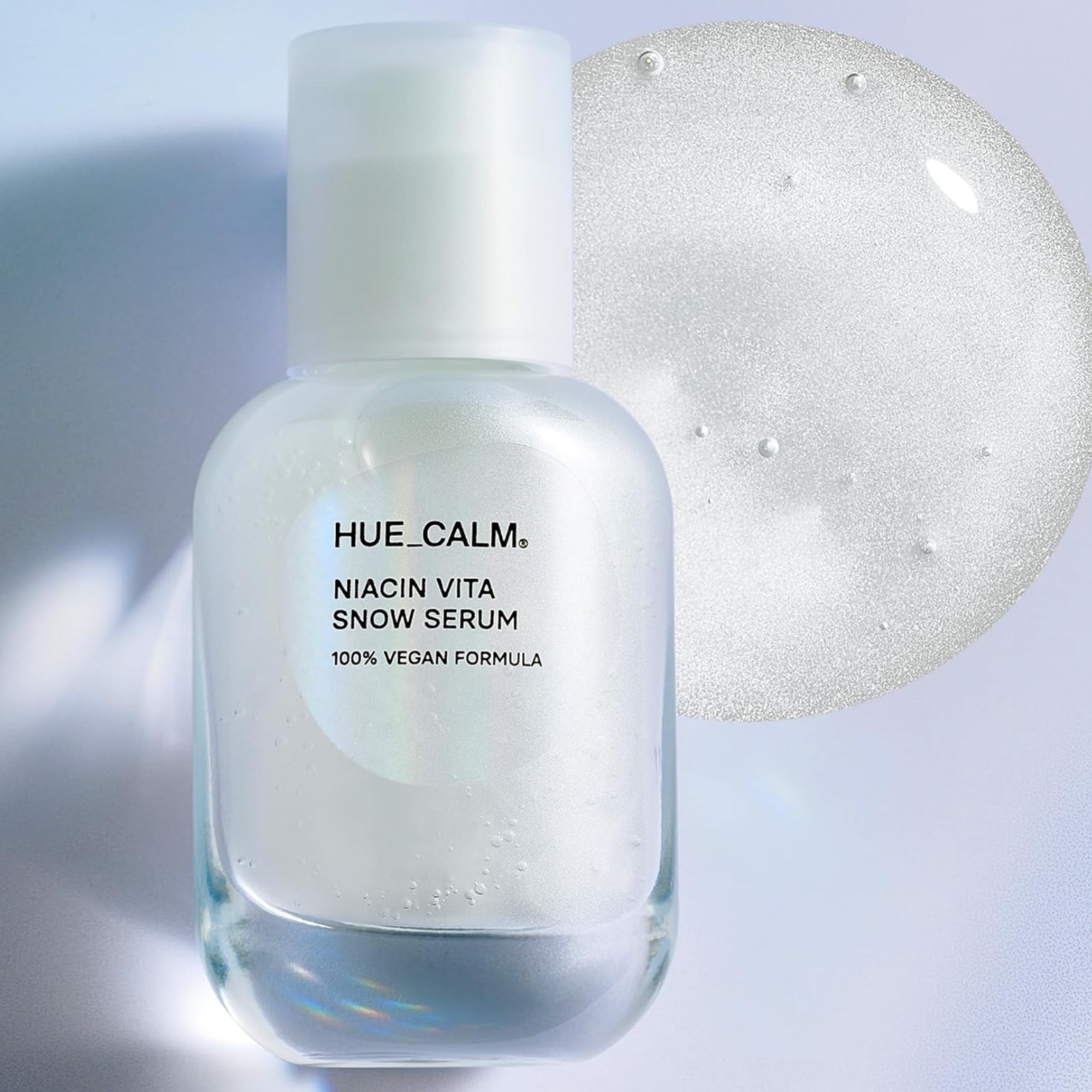 HUE_CALM Niacin Vita Snow Serum bottle with a white cap on a light gray background