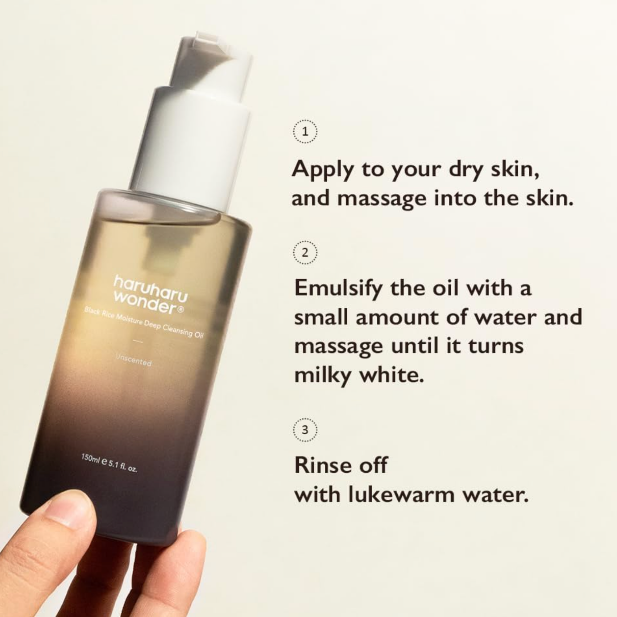 Hand holding a bottle of skincare oil with usage instructions on a light background