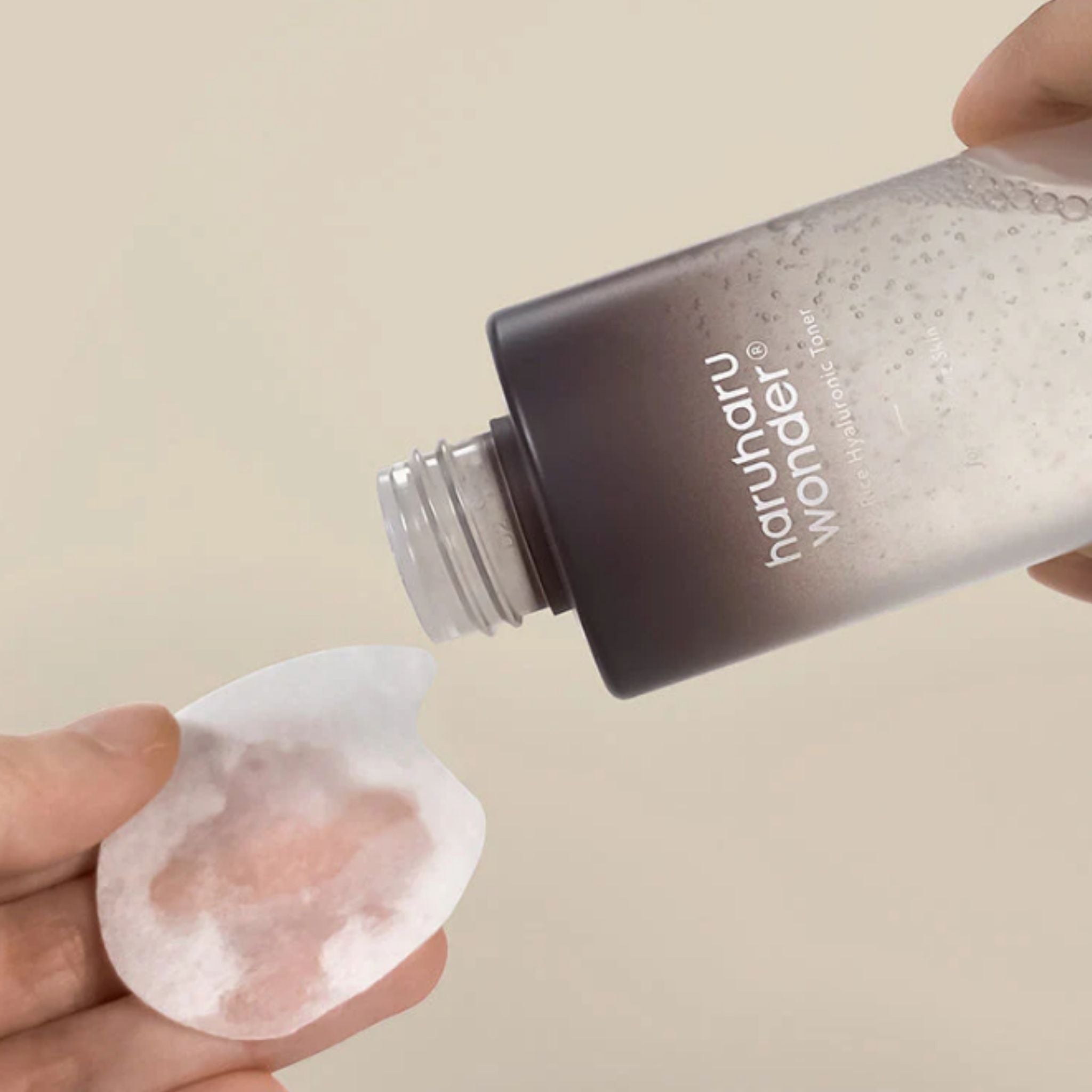 Haruharu Wonder Black Rice Hyaluronic Toner poured onto a cotton pad